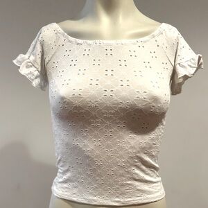 White crop top with slightly ruffled sleeve, scooped neckline.  Gently worn
